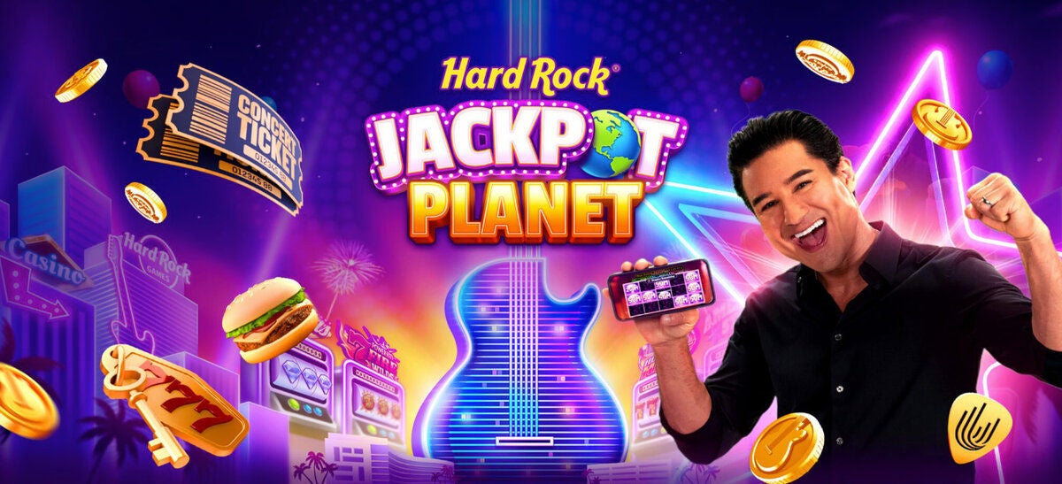 a man holding a cell phone and a guitar