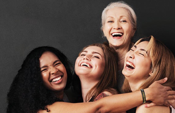 Women smiling and embracing each other